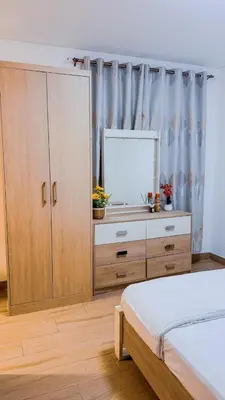 a bedroom with a bed and a mirror and a dresser at Luxurious Studio Apartment in Dubai