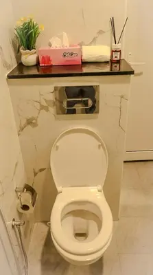 a white toilet in a bathroom with a counter at Luxurious Studio Apartment in Dubai