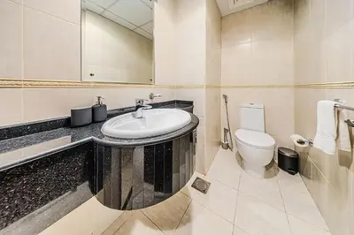 a bathroom with a sink and a toilet at Cozy 1 Bedroom in Elite Residence in Dubai