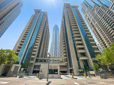 three tall buildings in front of a city at Boulevard Central Towers Downtown Dubai - By Home Of Choice in Dubai