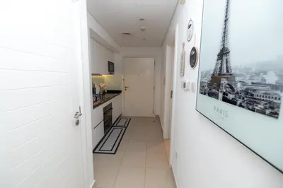 a hallway with white walls and a staircase with the eiffel tower at Boulevard Central Towers Downtown Dubai - By Home Of Choice in Dubai