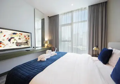 a hotel room with a bed with two towels on it at Luxury Studio Apartment Canal View Near Dubai Mall in Dubai