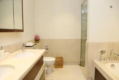 a bathroom with two sinks and a toilet and a shower at Luxury Two Bedroom Apt Facing Burj Khalifa in Dubai