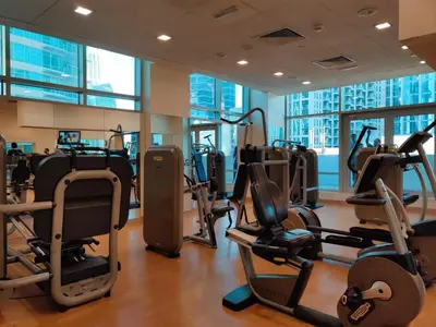 a gym with treadmills and ellipticals in a building at Luxury Two Bedroom Apt Facing Burj Khalifa in Dubai