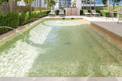 a pool of water with some chairs in it at Sea-facing 1BR at Beachfront 50 Off Eid Promo in Dubai