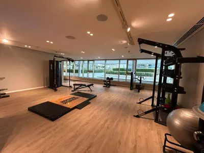 a room with a gym with a treadmill and exercise equipment at Sea-facing 1BR at Beachfront 50 Off Eid Promo in Dubai