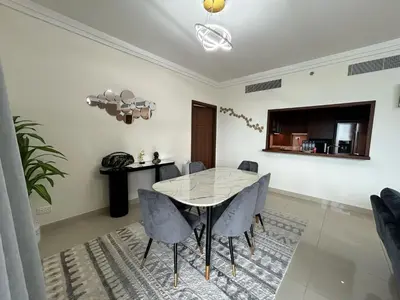 a dining room with a table and chairs at 2BR Full Burj Khalifa View - Eid Promo 50 Off in Dubai