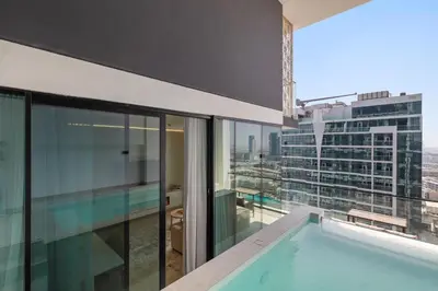 a swimming pool on the balcony of a building at Your Own Pool Spacious 2BDR Apartment JVC in Dubai