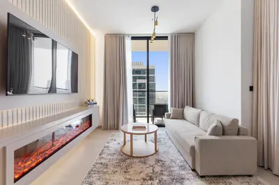 a living room with a couch and a fireplace at Your Own Pool Spacious 2BDR Apartment JVC in Dubai