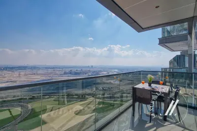 a glass balcony with a table and chairs on it at 3BDR Business Bay Bliss High Floor Private Balcony in Dubai