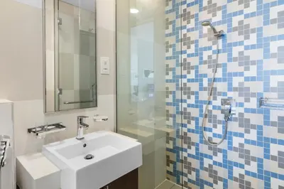 a bathroom with a sink and a shower at Bright Beachfront Studio with Breathtaking Views in Dubai