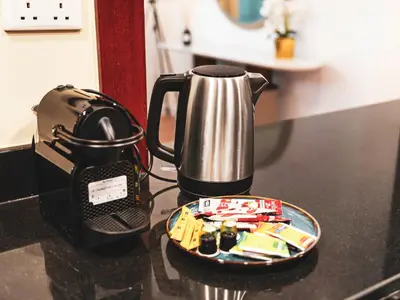 a tea kettle and a plate on a kitchen counter at New! JBR Beachfront with Panoramic Dubai Eye Views in Dubai