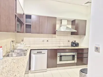 a kitchen with a sink and a dishwasher at The Palm Panorama Chic Apartment with Open Sea Views Managed by SunnyHomes in Dubai