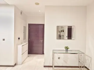 a hallway with a glass table and a mirror at The Palm Panorama Chic Apartment with Open Sea Views Managed by SunnyHomes in Dubai