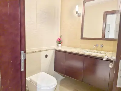 a bathroom with a toilet and a sink and a mirror at The Palm Panorama Chic Apartment with Open Sea Views Managed by SunnyHomes in Dubai