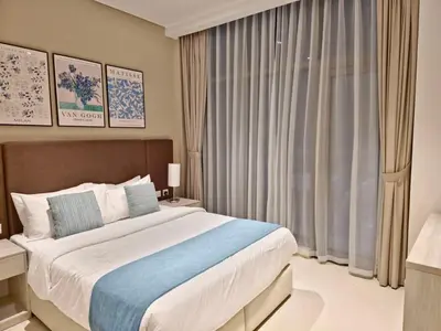 a bedroom with a large bed and a window at The Palm Hideaway Chic Apartment with Rooftop Vibes Managed by SunnyHomes in Dubai