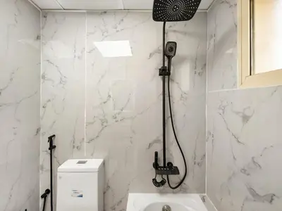 a shower in a bathroom with a toilet at Cozy Home w Spectacular Water View in Dubai