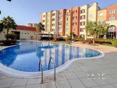 a large swimming pool in front of a building at Rare Holiday Homes - Mediterranean Cluster - Near Ibn Battuta Mall - Discovery Garden - Building# Med 38 - RG04 in Dubai