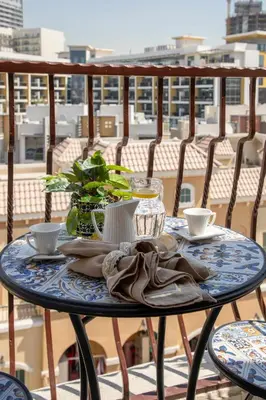 a table on a balcony with a view of a city at Frank Porter - Rokane G22 in Dubai