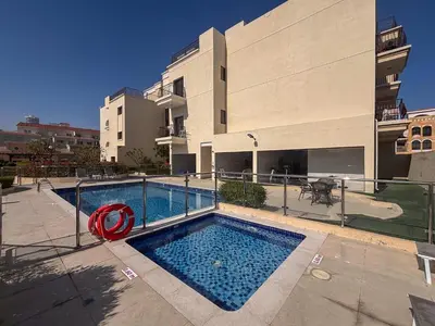 a swimming pool in front of a building at Frank Porter - Rokane G22 in Dubai