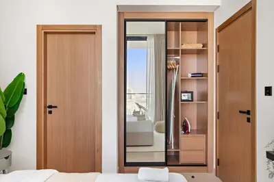 a bedroom with a sliding glass door with a shower at Silkhaus Classic 1BDR Apartment in Binghatti House in Dubai