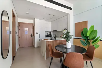 a kitchen and dining room with a table and chairs at Silkhaus Classic 1BDR Apartment in Binghatti House in Dubai