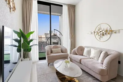 a living room with a couch and a table at FIRST CLASS 1BR Cozy Urban Getaway in Dubai