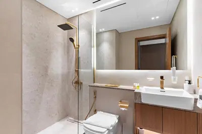a bathroom with a shower and a toilet and a sink at FIRST CLASS 1BR Cozy Urban Getaway in Dubai