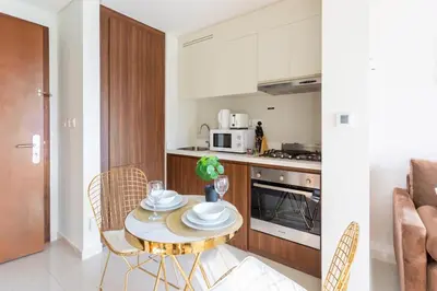 a kitchen with a table and chairs in a room at Full burj khalifa view 1bhk app in Dubai