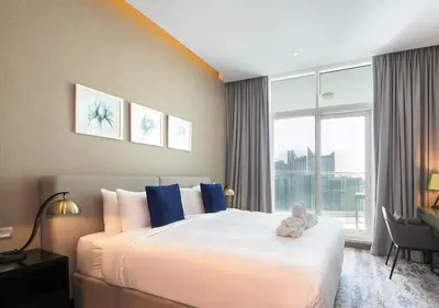 a bedroom with a bed with a teddy bear on it at Waterfront Studio with Balcony Near Dubai Mall in Dubai