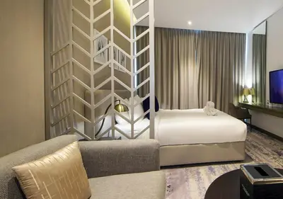 a hotel room with a bed and a couch at Waterfront Studio with Balcony Near Dubai Mall in Dubai