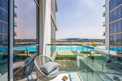 a balcony with a view of a swimming pool in a building at Charming 1 Bedroom Apt in MBR - Near Downtown Dubai in Dubai