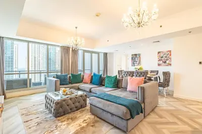 a living room with a couch and a table at Serene 2BR Escape - Al Majara - Waterfront Stay in Dubai