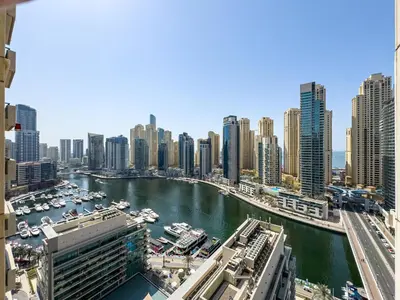 a view of a city with a river and buildings at Serene 2BR Escape - Al Majara - Waterfront Stay in Dubai