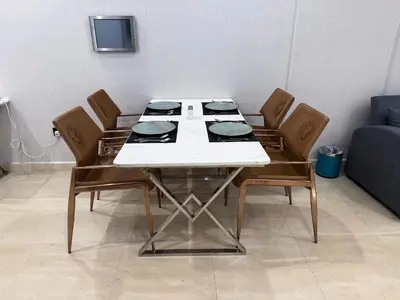 a dining room table with chairs and a white table at Holiday Homes by DO - Dubai Marina in Dubai