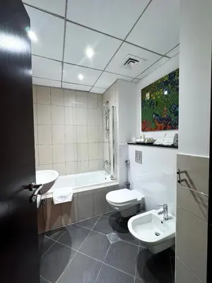 a bathroom with a sink and a toilet and a tub at Holiday Homes by DO - Dubai Marina in Dubai