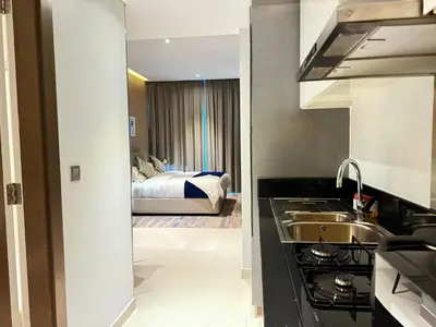 a kitchen with a sink and a bed in a room at Bellaviu Holiday Homes- Escape the Buzz-Your Quiet Spot in DAMAC Prive in Dubai