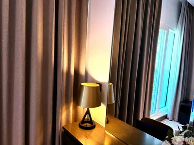 a lamp sitting on a desk next to a window at Bellaviu Holiday Homes- Escape the Buzz-Your Quiet Spot in DAMAC Prive in Dubai