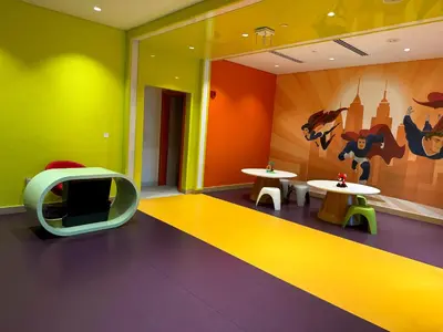 a room with two tables and a tv in it at Bellaviu Holiday Homes- Escape the Buzz-Your Quiet Spot in DAMAC Prive in Dubai