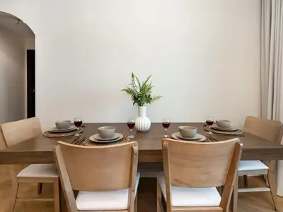 a dining room with a wooden table and chairs at Luxury 4BR - Full Marina View - High Floor Bliss in Dubai
