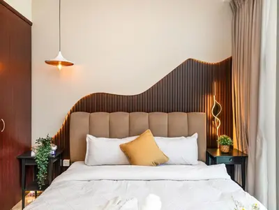 a bedroom with a large bed with a wooden headboard at Luxury 4BR - Full Marina View - High Floor Bliss in Dubai