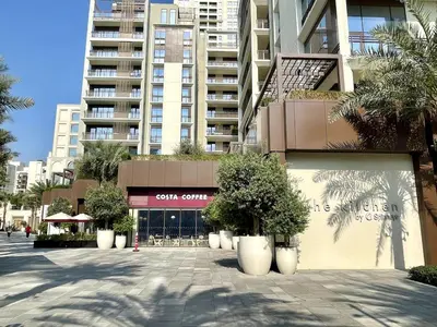 a building with trees in pots in front of a building at Beachfront Family Entire Unit in Dubai Ras Al-Khor in Dubai