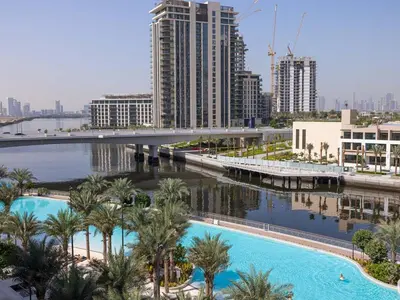 a view of a river with palm trees and buildings at Beachfront Family Entire Unit in Dubai Ras Al-Khor in Dubai