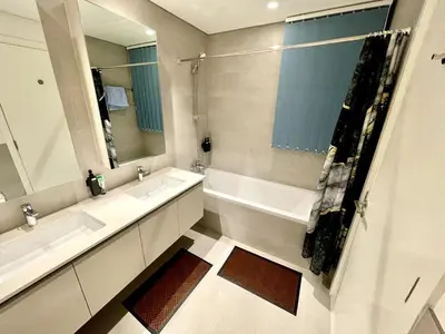 a bathroom with two sinks and a large mirror at Beachfront Family Entire Unit in Dubai Ras Al-Khor in Dubai
