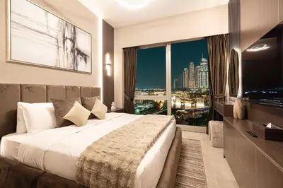 a hotel room with a large bed and a large window at NEW YEARS Luxury Burj Khalifa and Fountain Views in Dubai