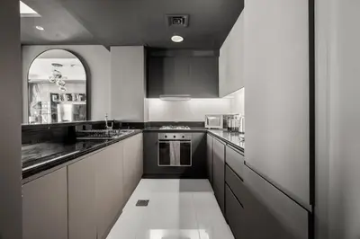 a kitchen with black and white cabinets and a sink at 5 Star Rooftop Infinity Pool with Burj Khalifa Views in Dubai