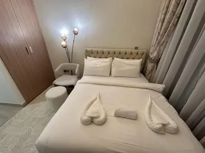 a bedroom with two beds with white towels on them at Studio Designer Azizi 41 in Dubai