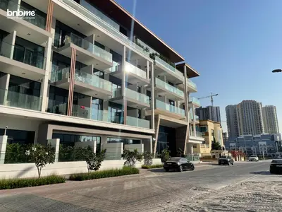 a large apartment building with cars parked in front of it at bnbmehomes - Oxford Terraces in Dubai