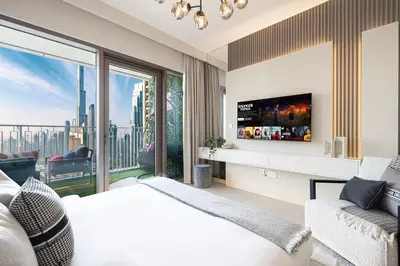 a bedroom with a bed and a large window at Elite 4 Bedroom Luxury Apartment, Burj Khalifa View, Opposite Dubai Mall, Infinity Swimming Pool in Dubai