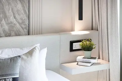a bedroom with a bed and a tv on a wall at Elite 4 Bedroom Luxury Apartment, Burj Khalifa View, Opposite Dubai Mall, Infinity Swimming Pool in Dubai